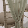 Soft chiffon chair drape elegantly tied on wedding chair